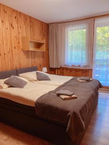 a bedroom with a large bed and a large window at OWR Universal in Łazy