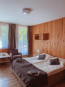 a bedroom with a large bed and a chair at OWR Universal in Łazy