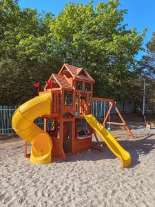 a playground with a slide in the sand at OWR Universal in Łazy