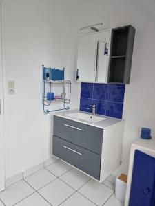 a bathroom with a sink and a mirror at Brittany Beach Home Gavres - Morbihan in Porh-Guer