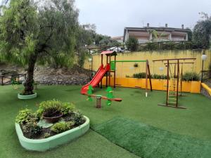 a playground with a slide and a swing at Residence Belvedere in Ascea