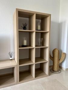 uma estante de livros de madeira numa sala de estar em Apartamento en San Fernando centro em San Fernando