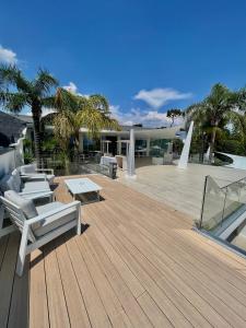 a wooden deck with chairs and tables on a house at BMC Home in Boscotrecase