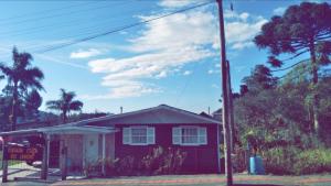 a red house with a sign in front of it at Pousada Costa dos Canions in Cambará +10 photos