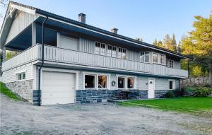 a large white house with a garage at Cozy Apartment In Gol With Wifi in Gol