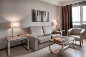 a living room with a couch and a table at AC Hotel Iberia Las Palmas by Marriott in Las Palmas de Gran Canaria