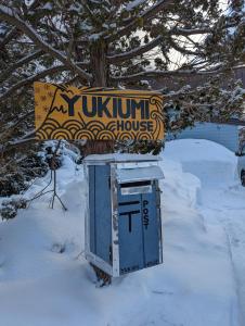 a box in the snow next to a sign at Yukiumi House in Kamikawa