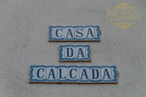 three blue and white street signs on a wall at Casa da Calçada in Pinhão