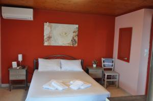 a bedroom with a bed with two towels on it at VILLA SOFIA in Nea Vrasna