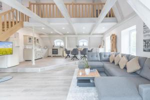 a living room with a couch and a table at Nordisch noble Lebensart WE 1 in Bargum
