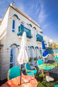 a patio with chairs and tables and a building at Skyrock Dahab in Dahab