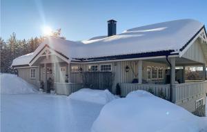 a house covered in snow with snow piled up at Awesome Apartment In Gol With Wifi And 2 Bedrooms in Gol