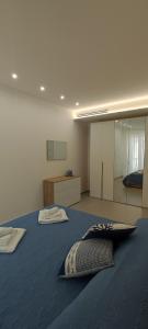 a bedroom with a large blue bed with a mirror at A casa di Fiore, holiday home in Giovinazzo