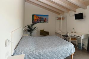 a bedroom with a bed and a desk and a computer at Ca' del Portego in Tessera