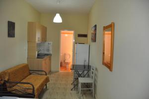 a living room with a couch and a kitchen at VILLA SOFIA in Nea Vrasna