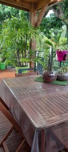 a wooden table with plants on a patio at KAZ A NINE in Saint-Pierre