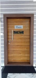 a wooden garage door with a sign on it at Reunion Ocean Manor - Beach House in Udupi