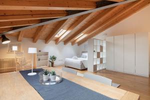 a room with a bed and a table and chairs at Apartments Trieste Centro I 2 in Trieste