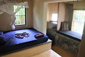 a bedroom with a bed and a window with shoes on it at The Spice House Mirissa in Mirissa