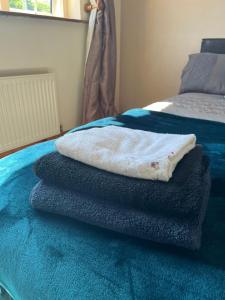 a pile of towels sitting on top of a bed at graiguenamanagh Homestay in Graiguenamanagh