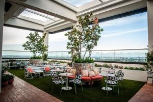 a patio with tables and chairs and large windows at Element Fort Lauderdale Downtown in Fort Lauderdale