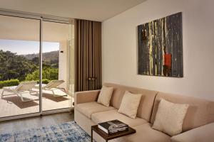 a living room with a couch and a table at Penha Longa Resort in Sintra