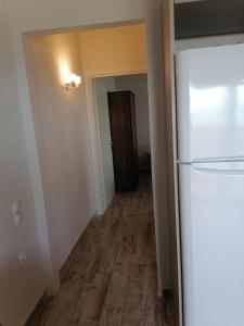 an empty hallway with a refrigerator and a door at Panoramic view in Preveza
