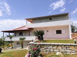a white house with a stone wall at Panoramic view in Preveza