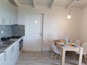 a kitchen with a table and chairs and a table and a table and a kitchen at Panoramic view in Preveza