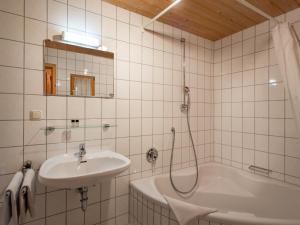 a bathroom with a sink and a bath tub at Berggasthof Bichlersee in Oberaudorf