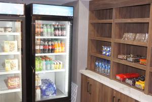 a kitchen with two refrigerators with food and drinks at La Quinta Inn & Suites by Wyndham Manchester - Arnold AFB in Manchester