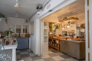 a large kitchen with a counter and a kitchen island at Odyssey Suites in Poros