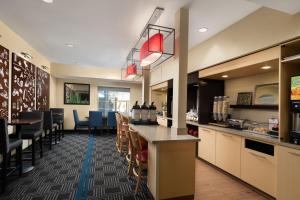 a restaurant with a bar and some chairs at TownePlace Suites San Jose Cupertino in San Jose