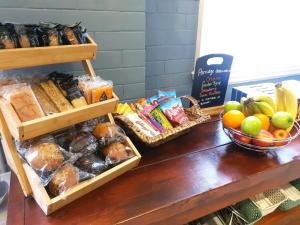 a table topped with baskets of bread and other food at Park Hotel & Apartments in Hull