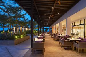 a restaurant with tables and chairs on a patio at The Westin Desaru Coast Resort in Desaru