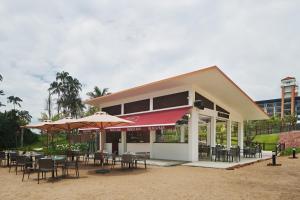 a restaurant with tables and chairs and umbrellas at The Westin Desaru Coast Resort in Desaru