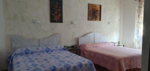 A bed or beds in a room at Le Rustiche Foresteria