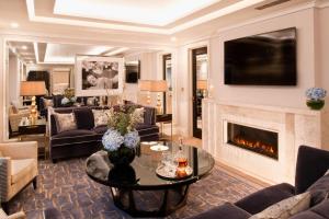 a living room with a fireplace and a couch at The Wellesley, a Luxury Collection Hotel, Knightsbridge, London in London