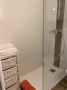 a shower with a glass door in a bathroom at Studio pieds dans l'eau in Algajola