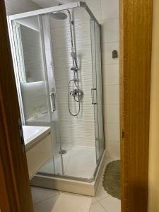 a bathroom with a glass shower and a sink at Room21 FREE GARAGE in Novi Sad
