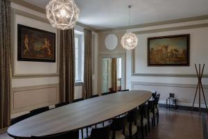 a dining room with a table and chairs at Grand Universe La Residenza in Lucca