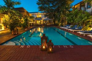 a swimming pool in a resort at night at Protea Hotel by Marriott Dar es Salaam Oyster Bay in Dar es Salaam