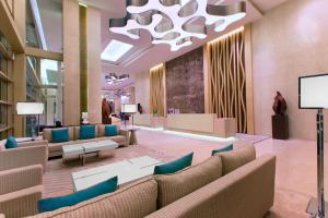 a lobby with couches and a chandelier at The Westin Chennai Velachery in Chennai