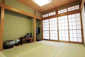 志摩の別荘 في شيما: غرفة مع غرفة كبيرة مع نافذة كبيرة