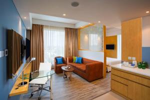 a living room with a couch and a table at Four Points by Sheraton Chennai OMR in Chennai