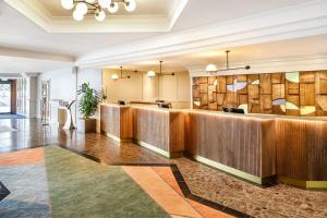 a lobby of a hotel with a reception desk at Delta Hotels by Marriott Warwick in Warwick