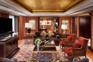 a living room with a couch and a tv at The St. Regis Beijing in Beijing