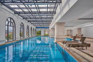 a large pool with blue water in a building at Four Points by Sheraton Lang Son in Lạng Sơn