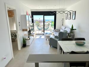 a living room with a couch and a table at Penthouse 2-Rooms with Private Jacuzzi in the Solarium in Orihuela Costa