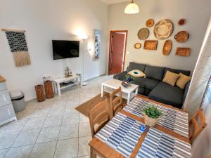 a living room with a couch and a table at Ritzi Apartment in Symi